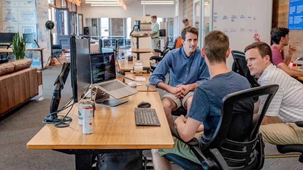 Two men sitting at a desk in an agency