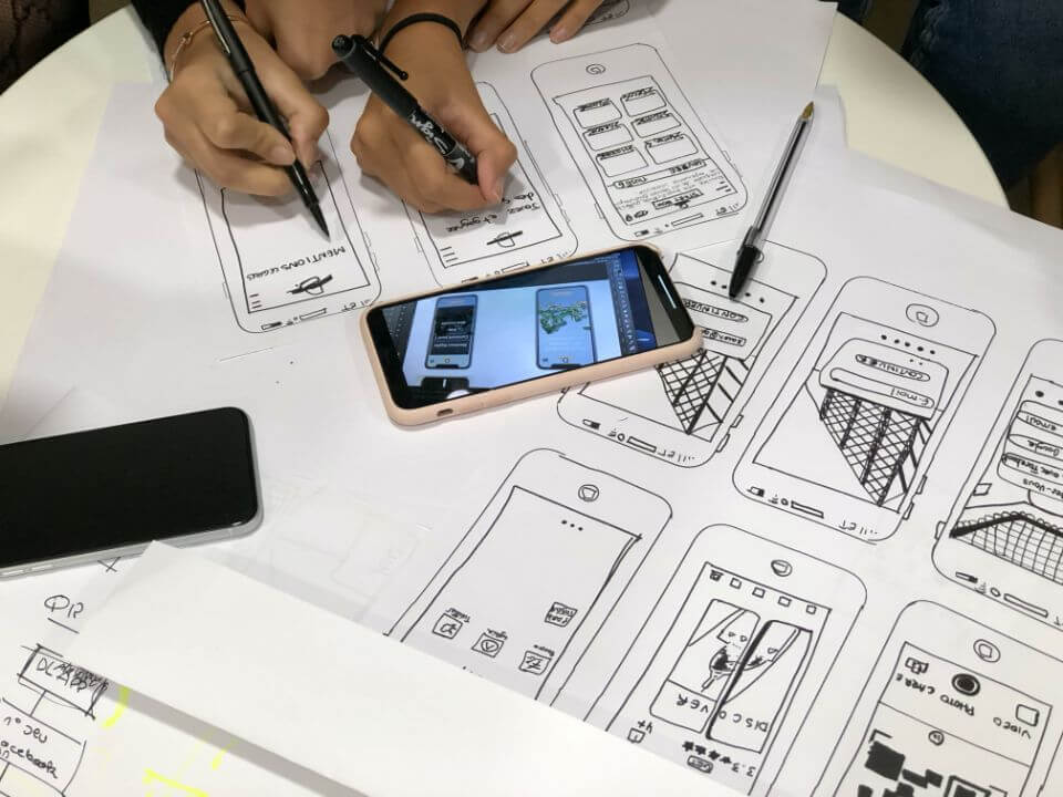 Cell phone and drawing plans on a table