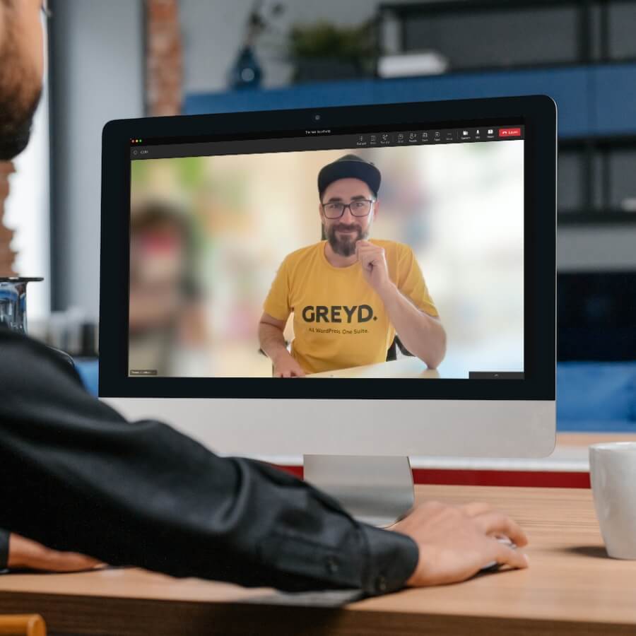 Someone sitting in front of a screen showing Thomas in a video call